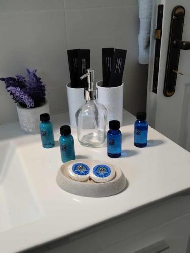 a white counter with blue bottles on top of it at Beachfront Villa Gia Paros in Kampos Paros