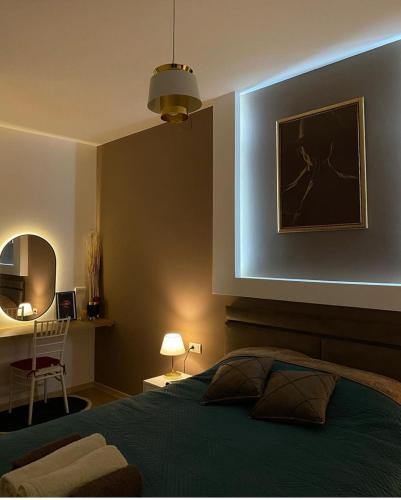 a bedroom with a green bed and a mirror at Drobnjak apartments in Bijelo Polje