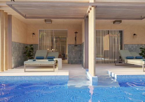 eine Villa mit einem Pool neben einem Haus in der Unterkunft HD Lobos Natura Fuerteventura in Corralejo