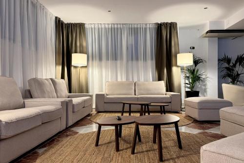a living room with two couches and a table at Hotel Don Ignacio in San José