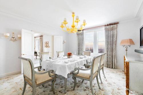 a dining room with a table and chairs and a chandelier at The Pierre, A Taj Hotel, New York in New York