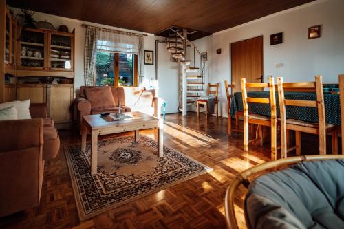 a living room with a table and chairs at Cozy family place 'Hiša Grozdek' - Gruškovec 40A in Gruškovec