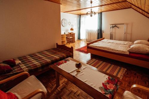 1 dormitorio con 2 camas, mesa y sillas en Cozy family place 'Hiša Grozdek' - Gruškovec 40A en Gruškovec