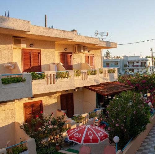 a building with a patio with an umbrella at Hotel Elida in Platanes