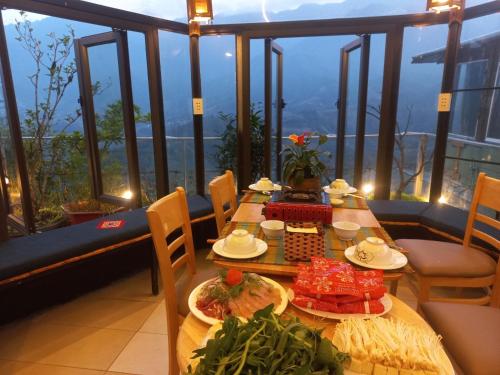 a table with food on top of a balcony at VALLEY VIEW COFFEE & STAY in Sa Pa