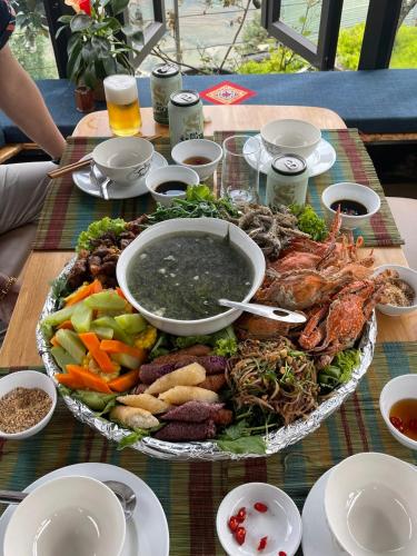 a table with a large plate of food on a table at VALLEY VIEW COFFEE & STAY in Sa Pa