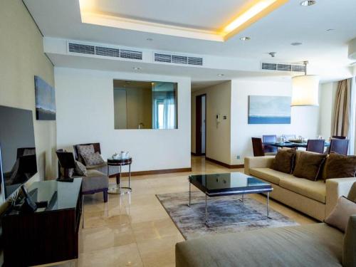 a living room with a couch and a table at Fashion avenue Dubai Mall -The Residence in Dubai