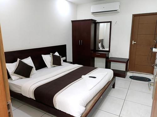 a bedroom with a large bed in a room at Grace Tourist Home in Ernakulam