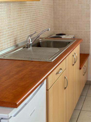 a kitchen with a sink and a counter top at LefCoast AURA Apartments in Paralía Avdhíron