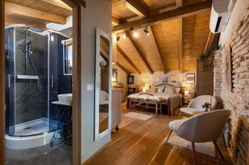 a bedroom with a bed and a bathroom with a shower at Casa Kaligari history in Rovinj