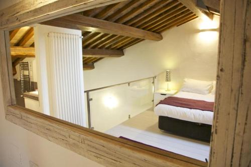 a bedroom with a bed and a glass window at La Colombaia Nel Castello in Bracciano