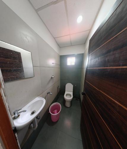 a bathroom with a sink and a toilet at Grace Tourist Home in Ernakulam