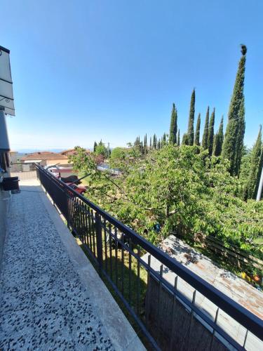 a fence in front of a garden with trees at La casa dì Nonno in Pelago