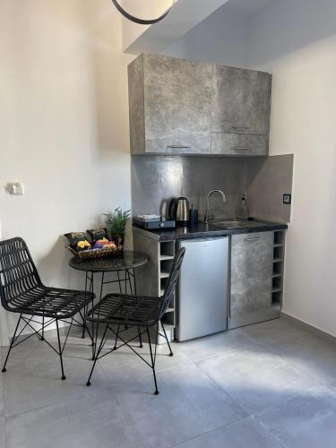 a kitchen with a sink and a table with chairs at Zoumis Residence in Naousa