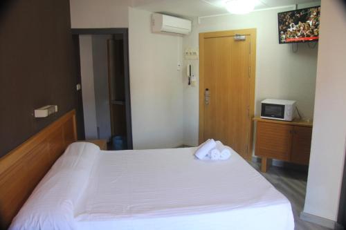 Ένα ή περισσότερα κρεβάτια σε δωμάτιο στο Aparthotel Els Molins