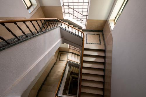 a spiral staircase in a building with a window at Ducrot Apartment in Palermo