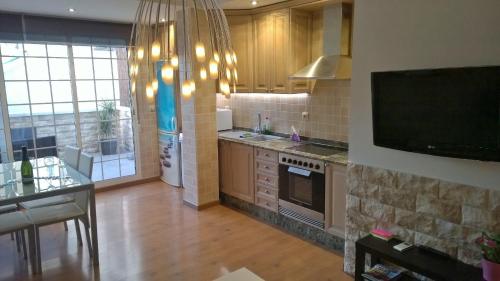 cocina con TV y encimera en Apartment Denia 66 en Valencia