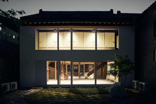 a house with large windows on the side of it at hotel jin #JIN in Tsushima