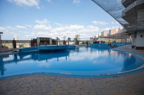 a large pool of blue water in a building at AIFU Hotel El Montazah Alexandria in Alexandria