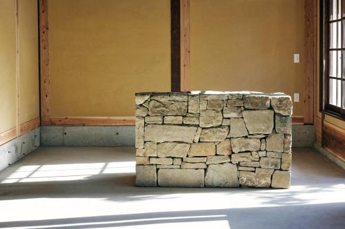 a stone wall in a room with a window at hotel jin #JIN in Tsushima