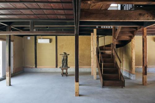 an empty room with a staircase in a building at hotel jin #JIN in Tsushima