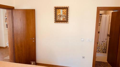 a room with a white wall and a mirror on the wall at Villa Vega in Kruče