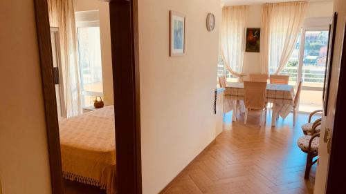 a bedroom with a bed and a dining room with a table at Villa Vega in Kruče