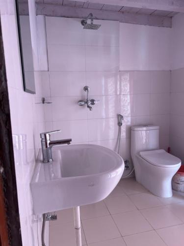 biała łazienka z umywalką i toaletą w obiekcie Hotel Dancing Yak w mieście Jomsom