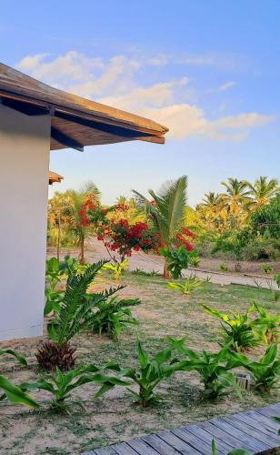 a view of a garden with flowers and trees at Coral Villa - Beachfront Villa with Private Pool by Karula in Inhambane