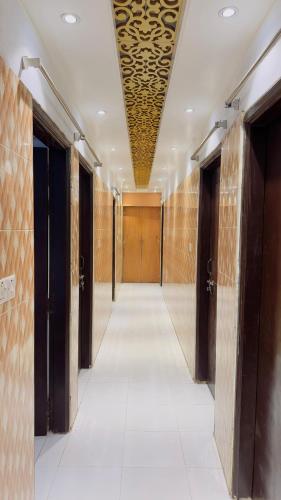 a hallway with wooden doors and a ceiling with a hallwayngthngthngthngthngth at Hotel Priyatama Residential in Dhaka