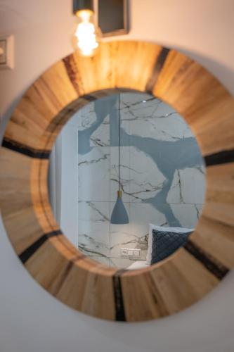 a round mirror with a reflection of a room at Katerina Roza Studios - Heartfelt Hospitality in the City in Naxos Chora