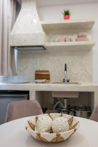 a basket sitting on a table in a kitchen at Katerina Roza Studios - Heartfelt Hospitality in the City in Naxos Chora