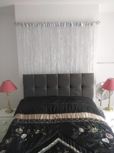 a bedroom with a black bed with a silver headboard at Hillside Residence in Carrick on Shannon