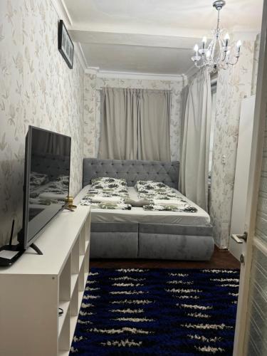 a bedroom with a bed and a tv and a desk at Timmy Apartment Ostrovni 4 Prague 1 in Prague