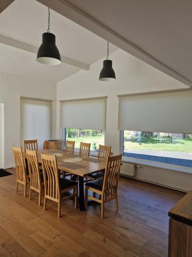 a dining room with a table and chairs at Villa Oši in Roja