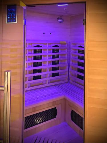 a sauna with purple lights in a room at Suite Spa et Sauna de Cogny in Cogny