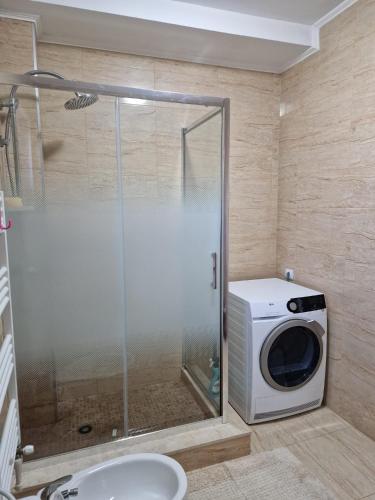 a shower in a bathroom with a washing machine at Villa Niko in Mamaia Sat/Năvodari