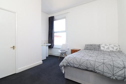 a bedroom with a bed and a window at Pebbles guest house room 5 in Southampton