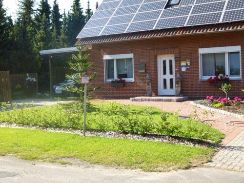 a house with solar panels on the roof at Angelikas Ferienparadies Angelika OG in Haselünne