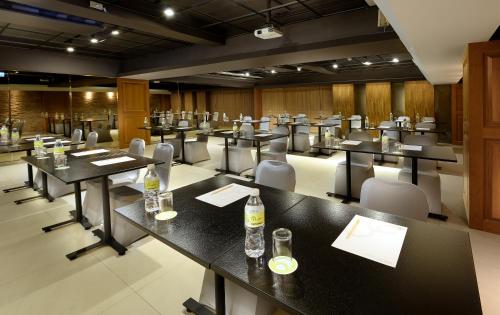 a conference room with tables and chairs and drinks on them at Hualien Holiday Hotel in Hualien City