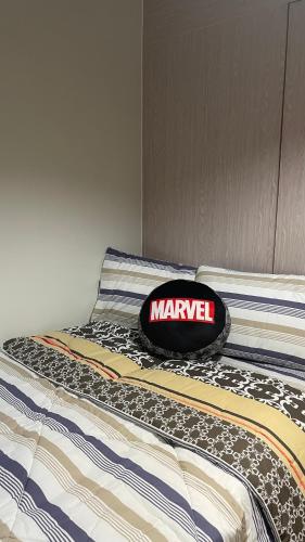 a bed with a hat on top of it at FLEXI Staycation in Manila