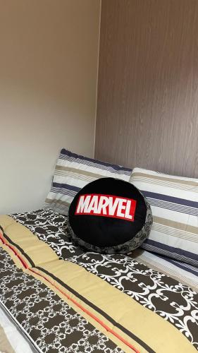 a bed with a mavericks bag on it at FLEXI Staycation in Manila