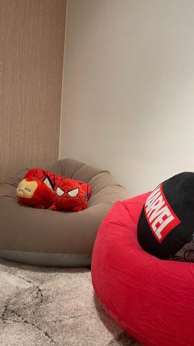 a red stuffed animal sitting on top of a bean bag chair at FLEXI Staycation in Manila