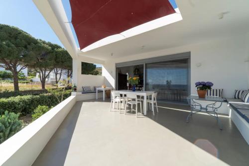 a balcony with a table and chairs and a view of the ocean at Villa Agios Isidoros in Gourna