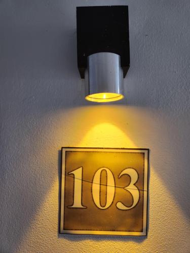 a light on a wall with a clock on it at MANGORO HOTEl in Moramanga