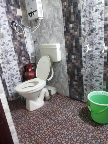 a bathroom with a toilet and a shower at Sahana Villa in New Hampi