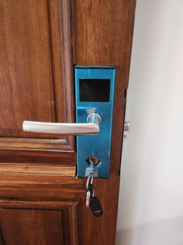a wooden door with a door knob and a lock at MANGORO HOTEl in Moramanga
