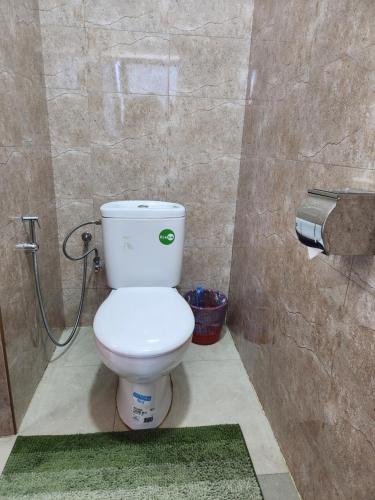 a bathroom with a white toilet in a stall at MANGORO HOTEl in Moramanga