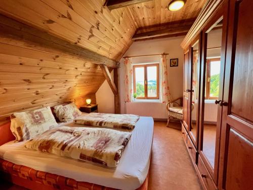 a bedroom with two beds in a log cabin at Holiday Home Celine in Velké Svatoňovice