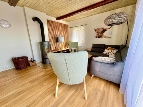 a living room with a couch and a chair at Holiday Home Celine in Velké Svatoňovice